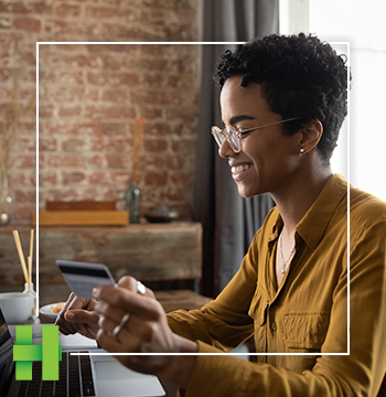 woman holding credit card and evaluating credit card bill