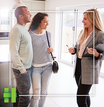 couple looking at home with realtor