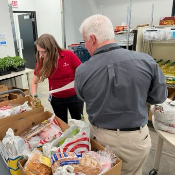 Hills Bank employees packing boxes of food at Coralville Community Food Pantry.