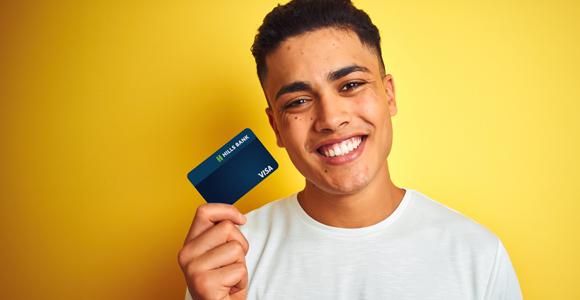 Man holding Hills Bank credit card