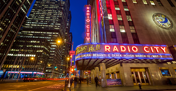 Radio City Music Hall lit up at night.