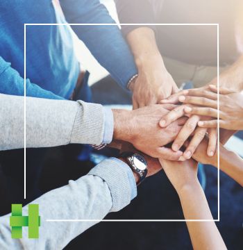 Hands coming together in a business environment. 
