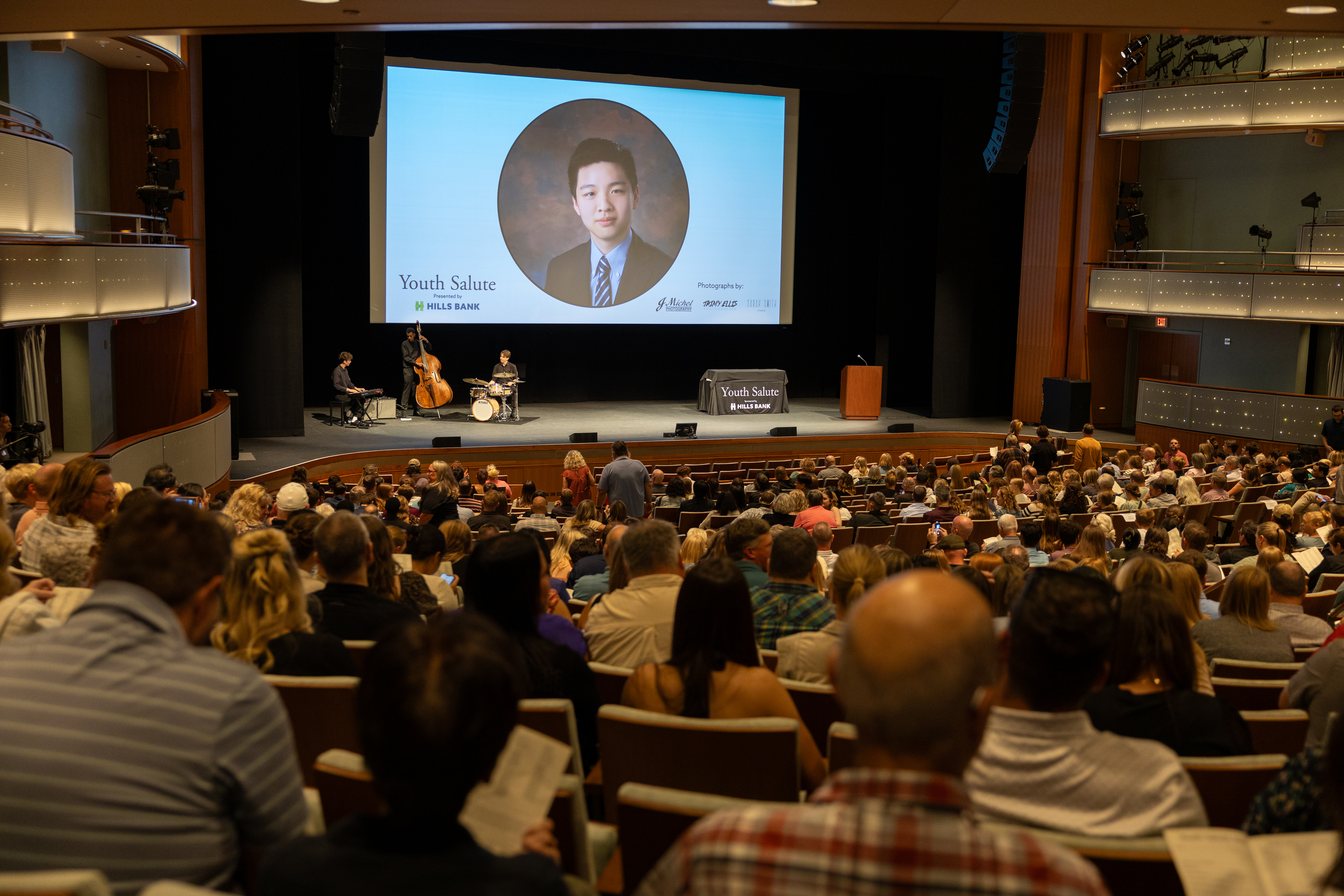 An auditorium filled with Youth Salute attendees viewing a presentation.