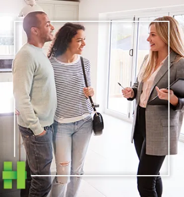 couple looking at home with realtor