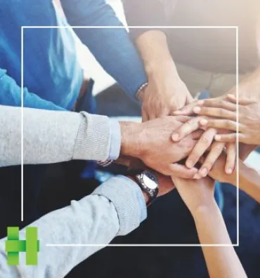 Hands coming together in a business environment. 